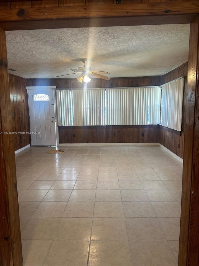 532 Bond, Clewiston, FL 33440 - empty room with wooden walls, ceiling fan, and a textured ceiling
