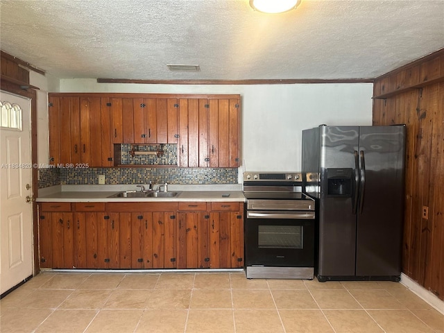 532 Bond, Clewiston, FL 33440 - kitchen with stainless steel appliances, brown cabinetry, light countertops, decorative backsplash, and a textured ceiling