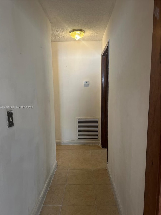 532 Bond, Clewiston, FL 33440 - hallway featuring light tile patterned floors and a textured ceiling