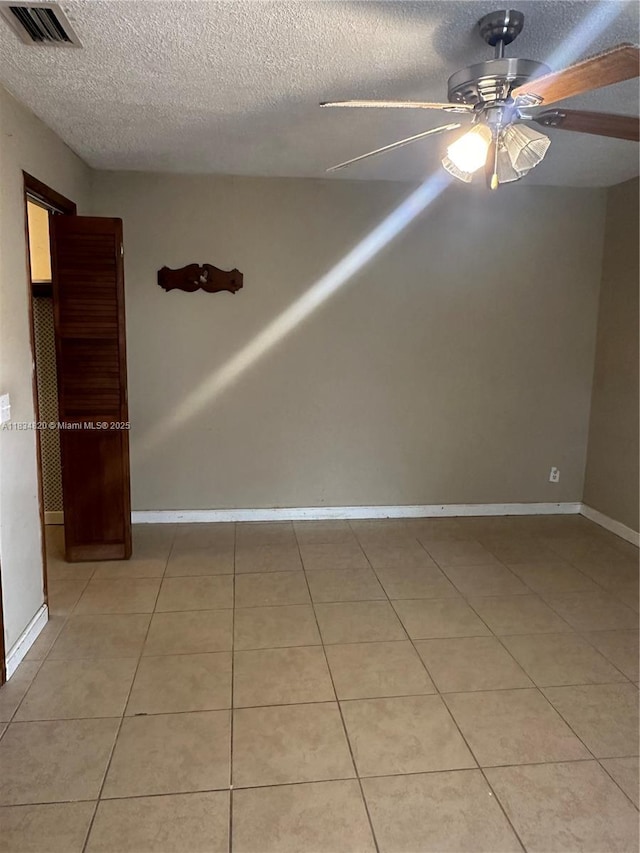 532 Bond, Clewiston, FL 33440 - empty room with a textured ceiling, a ceiling fan, and light tile patterned floors