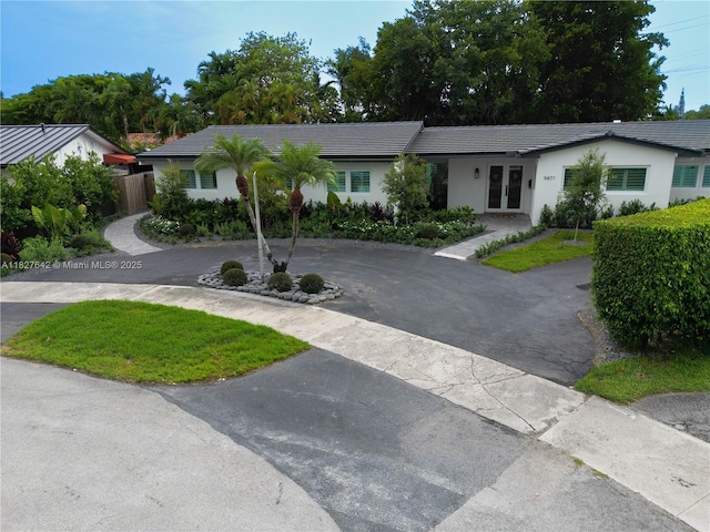 9471 SW 10th St, Miami, FL 33174 - single story home with french doors, a tile roof, curved driveway, and stucco siding