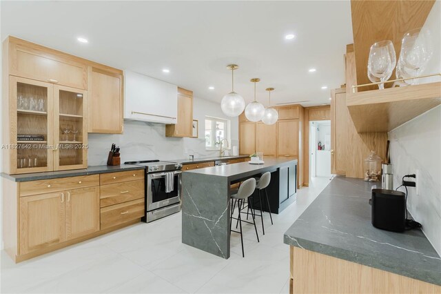 9471 SW 10th St, Miami, FL 33174 - kitchen featuring stainless steel electric range, light brown cabinets, dark countertops, a kitchen breakfast bar, and a kitchen island