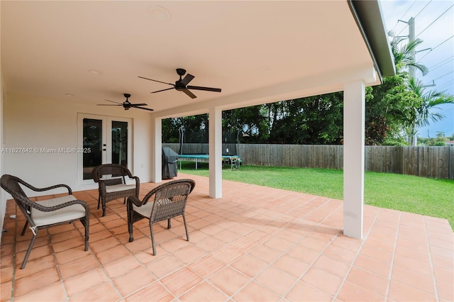 9471 SW 10th St, Miami, FL 33174 - fenced backyard with french doors, a trampoline, a patio, a ceiling fan, and a grill