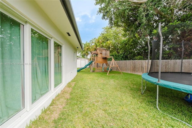 9471 SW 10th St, Miami, FL 33174 - fenced backyard with a trampoline, a playground, and a storage shed
