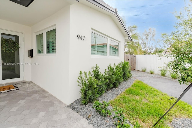 9471 SW 10th St, Miami, FL 33174 - view of side of property with stucco siding and a patio area
