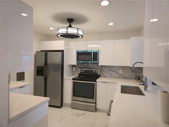 7771 NW 46th St, Lauderhill, FL 33351 - kitchen featuring stainless steel appliances, white cabinetry, recessed lighting, backsplash, and modern cabinets