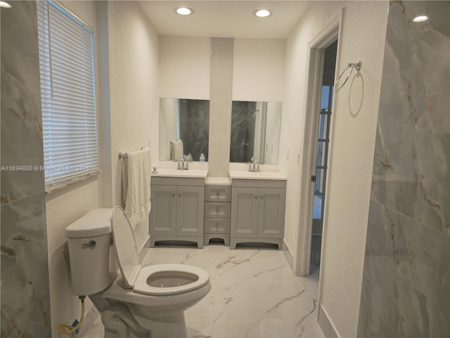 7771 NW 46th St, Lauderhill, FL 33351 - full bath with a textured wall, double vanity, marble tiled flooring, and recessed lighting