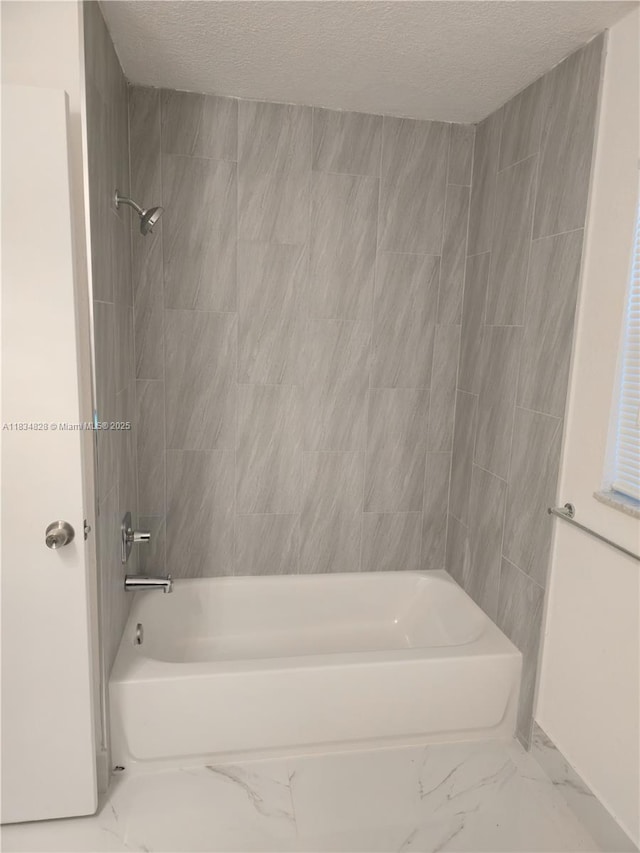 7771 NW 46th St, Lauderhill, FL 33351 - bathroom featuring marble finish floors, shower / bathtub combination, and a textured ceiling