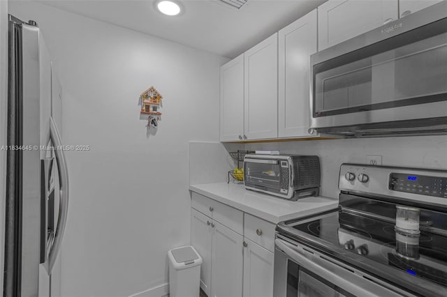 11955 SW 18th Ter Unit 9, Miami, FL 33175 - kitchen with stainless steel appliances, light countertops, and white cabinets