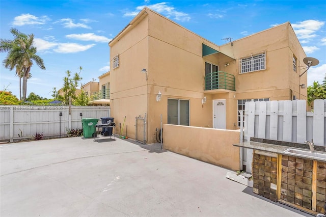 11955 SW 18th Ter Unit 9, Miami, FL 33175 - back of house with stucco siding and a patio