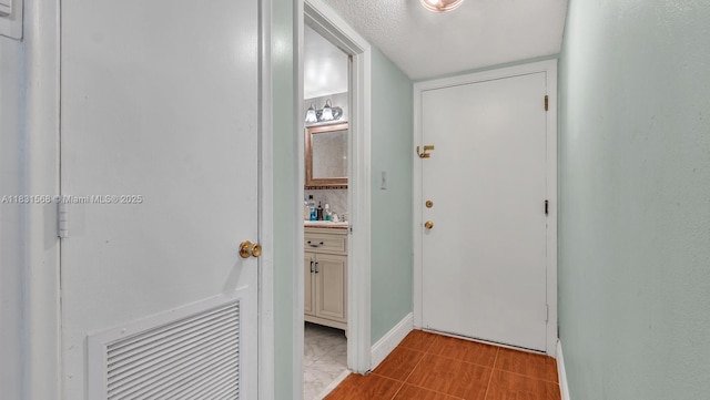 4821 NW 22nd Ct Unit 110, Lauderhill, FL 33313 - doorway to outside featuring a sink and baseboards
