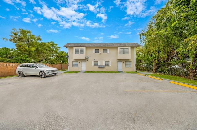 842 NW 1st Ave, Fort Lauderdale, FL 33311 - view of property with uncovered parking and stucco siding
