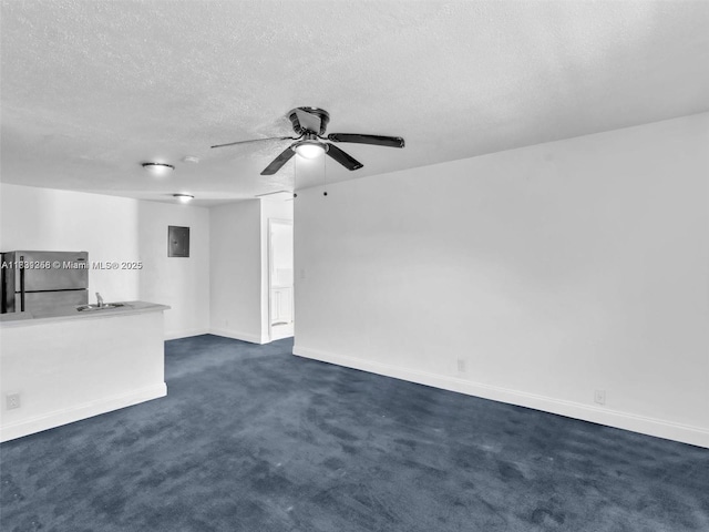 842 NW 1st Ave, Fort Lauderdale, FL 33311 - unfurnished living room with a textured ceiling, a ceiling fan, dark colored carpet, and electric panel
