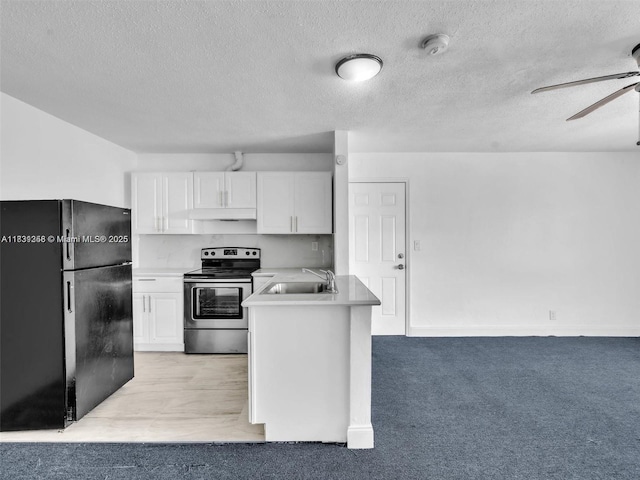 842 NW 1st Ave, Fort Lauderdale, FL 33311 - kitchen featuring freestanding refrigerator, stainless steel range with electric cooktop, a ceiling fan, white cabinets, and a textured ceiling