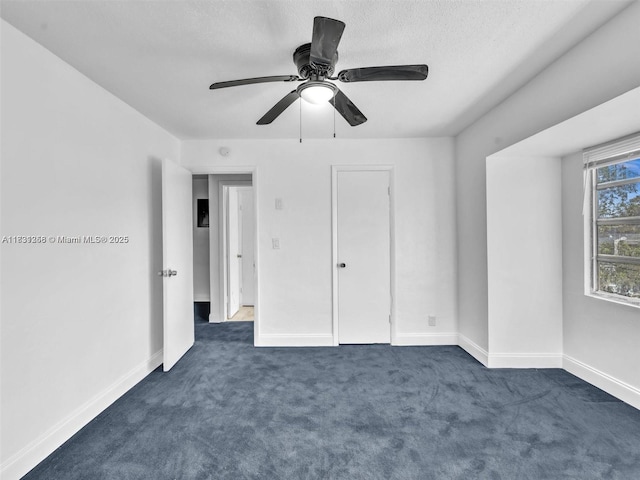 842 NW 1st Ave, Fort Lauderdale, FL 33311 - unfurnished bedroom with dark colored carpet, a ceiling fan, and a textured ceiling