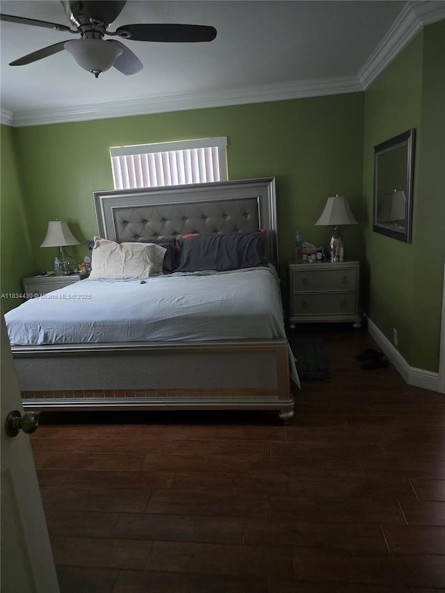 bedroom featuring ornamental molding, wood finished floors, and a ceiling fan