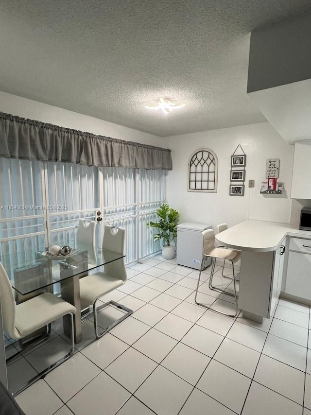 9370 W Flagler St Unit 104B, Miami, FL 33174 - dining area featuring a textured ceiling and light tile patterned flooring