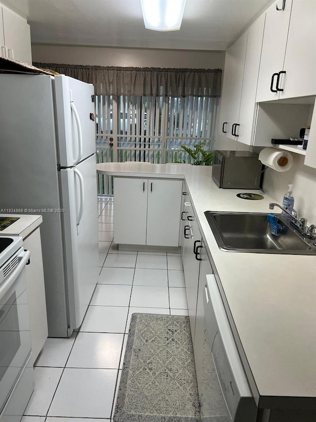 9370 W Flagler St Unit 104B, Miami, FL 33174 - kitchen featuring white appliances, healthy amount of natural light, white cabinetry, and light tile patterned flooring