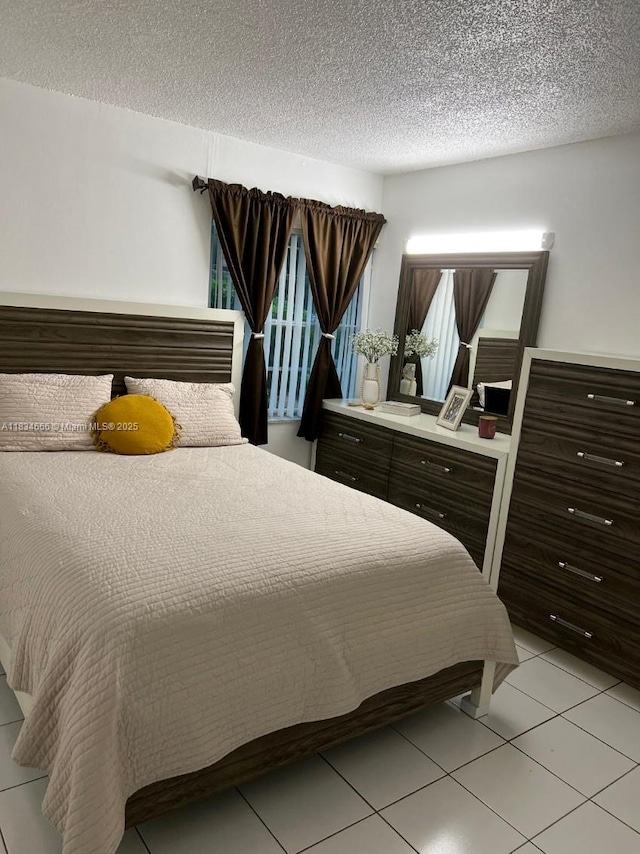 9370 W Flagler St Unit 104B, Miami, FL 33174 - bedroom featuring a textured ceiling and light tile patterned floors
