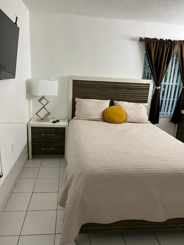 9370 W Flagler St Unit 104B, Miami, FL 33174 - bedroom featuring a textured ceiling and light tile patterned floors