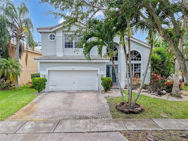 1891 SW 156th Ave, Miramar, FL 33027 - view of front facade featuring a garage, decorative driveway, stucco siding, and a tile roof