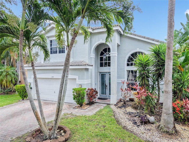 1891 SW 156th Ave, Miramar, FL 33027 - mediterranean / spanish house with a garage, stucco siding, decorative driveway, a tile roof, and french doors