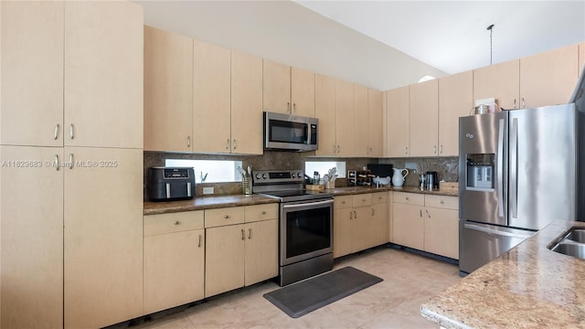 1891 SW 156th Ave, Miramar, FL 33027 - kitchen featuring appliances with stainless steel finishes, backsplash, cream cabinets, and light brown cabinets