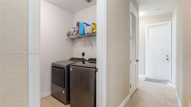 1891 SW 156th Ave, Miramar, FL 33027 - laundry room featuring light tile patterned floors, washer and clothes dryer, and a textured wall