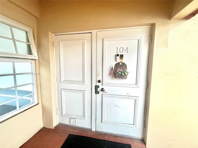 2841 NE 33rd Ct Unit 104, Fort Lauderdale, FL 33306 - doorway to property with stucco siding