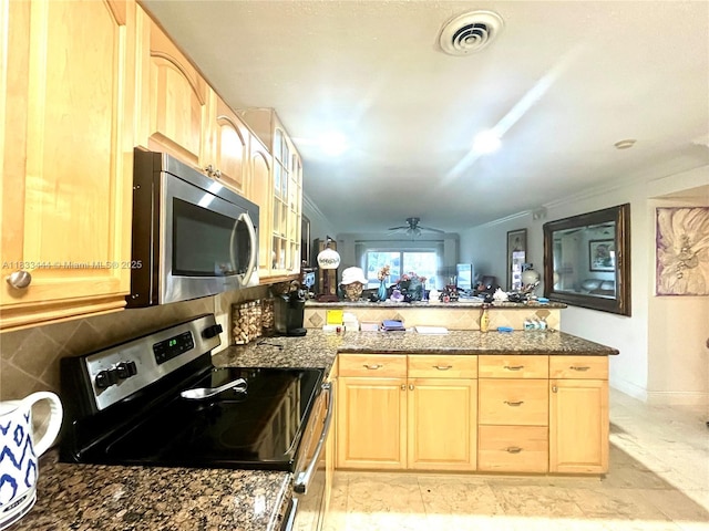 2841 NE 33rd Ct Unit 104, Fort Lauderdale, FL 33306 - kitchen with appliances with stainless steel finishes, a peninsula, light brown cabinetry, a ceiling fan, and glass insert cabinets