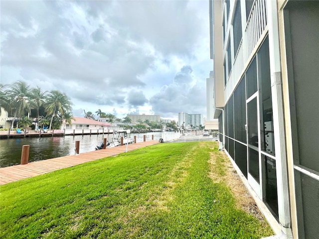 2841 NE 33rd Ct Unit 104, Fort Lauderdale, FL 33306 - view of green lawn with a water view and a boat dock