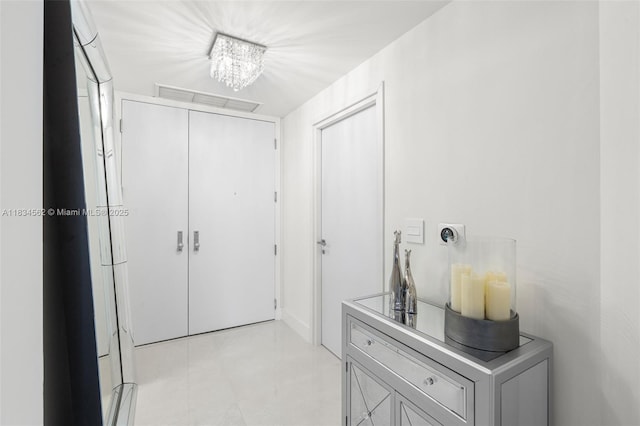 848 Brickell Key Dr Unit 2705, Miami, FL 33131 - hall featuring a chandelier