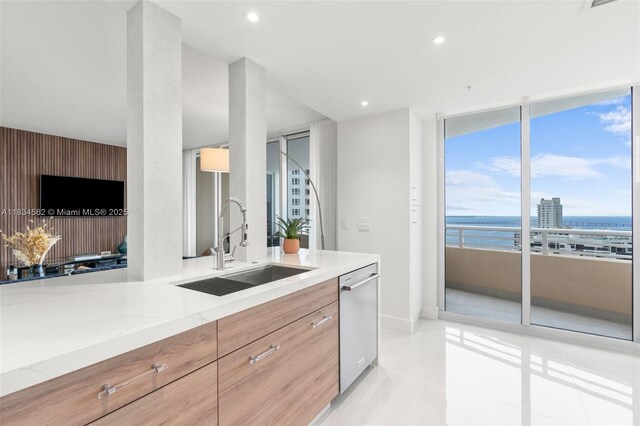 848 Brickell Key Dr Unit 2705, Miami, FL 33131 - kitchen with dishwasher, modern cabinets, light stone counters, light tile patterned floors, and recessed lighting