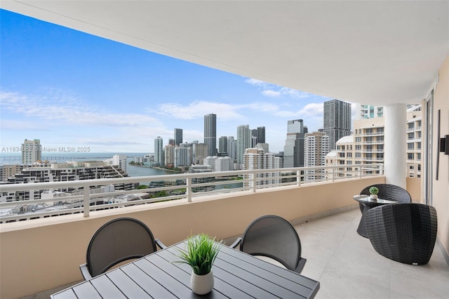 848 Brickell Key Dr Unit 2705, Miami, FL 33131 - balcony featuring a view of skyline, outdoor dining space, and a water view