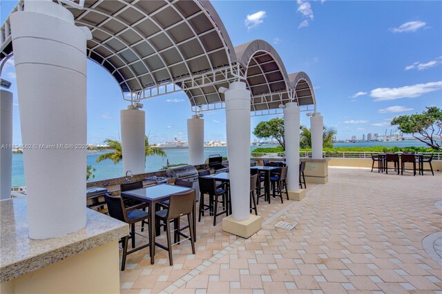 848 Brickell Key Dr Unit 2705, Miami, FL 33131 - view of patio / terrace with a water view and grilling area
