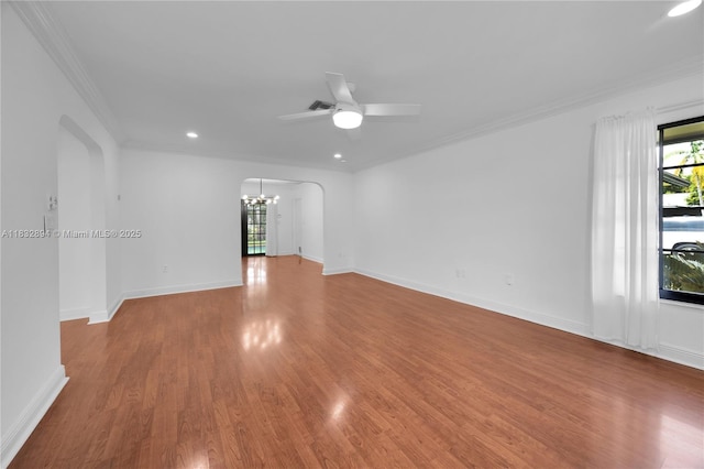7804 SW 178th Ter, Palmetto Bay, FL 33157 - unfurnished room featuring arched walkways, a chandelier, wood finished floors, a ceiling fan, and ornamental molding