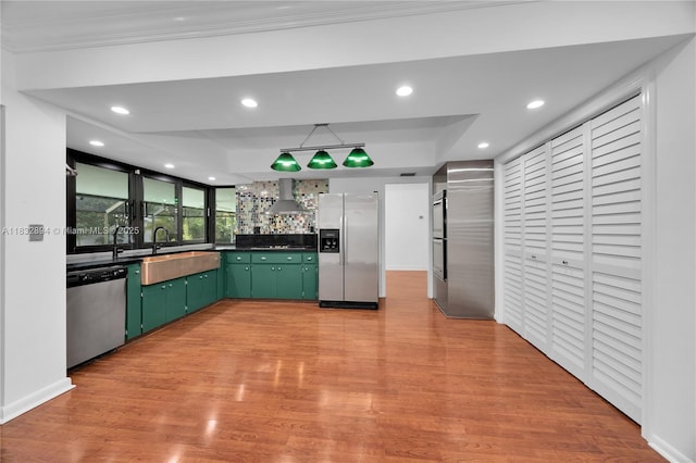 7804 SW 178th Ter, Palmetto Bay, FL 33157 - kitchen with stainless steel appliances, green cabinetry, wall chimney range hood, dark countertops, and recessed lighting