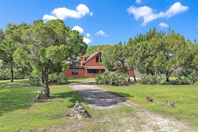 7264 159th Ct N, Palm Beach Gardens, FL 33418 - view of property hidden behind natural elements featuring a front lawn and driveway