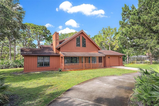 7264 159th Ct N, Palm Beach Gardens, FL 33418 - view of front of home with covered porch, a garage, concrete driveway, a chimney, and a front lawn