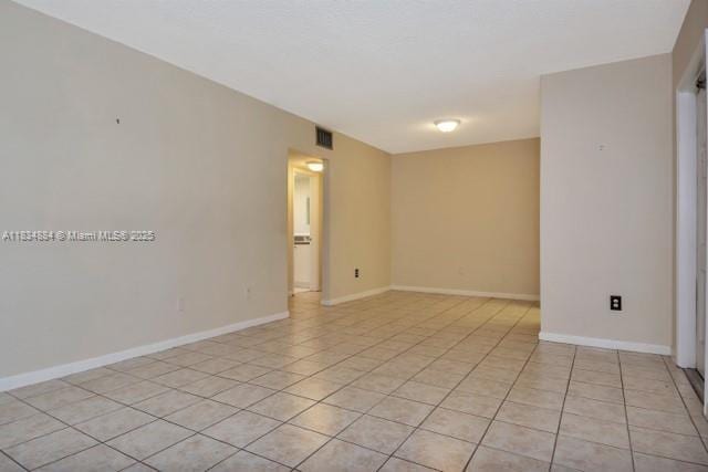 2101 NE 68th St Unit 103, Fort Lauderdale, FL 33308 - empty room featuring light tile patterned floors and baseboards