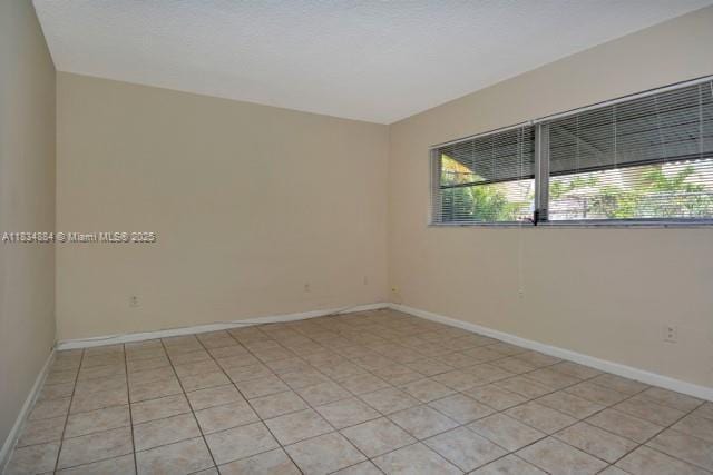 2101 NE 68th St Unit 103, Fort Lauderdale, FL 33308 - unfurnished room featuring healthy amount of natural light and light tile patterned floors