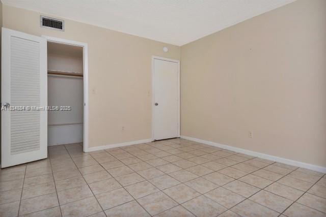 2101 NE 68th St Unit 103, Fort Lauderdale, FL 33308 - unfurnished bedroom featuring a closet and light tile patterned flooring