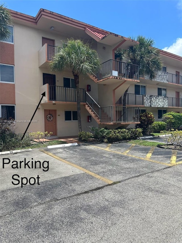 5945 Del Lago Cir Unit 201, Sunrise, FL 33313 - view of building exterior with uncovered parking