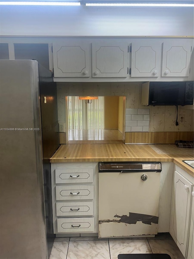 5945 Del Lago Cir Unit 201, Sunrise, FL 33313 - kitchen with freestanding refrigerator, white dishwasher, black microwave, light countertops, and decorative backsplash