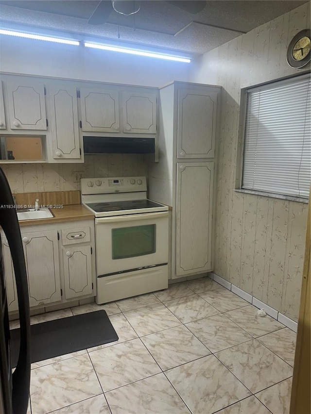 5945 Del Lago Cir Unit 201, Sunrise, FL 33313 - kitchen with white electric range oven, under cabinet range hood, wallpapered walls, black fridge, and light countertops