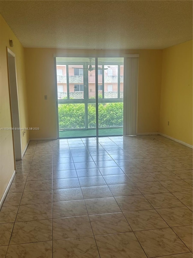 5945 Del Lago Cir Unit 201, Sunrise, FL 33313 - unfurnished room with baseboards and a textured ceiling