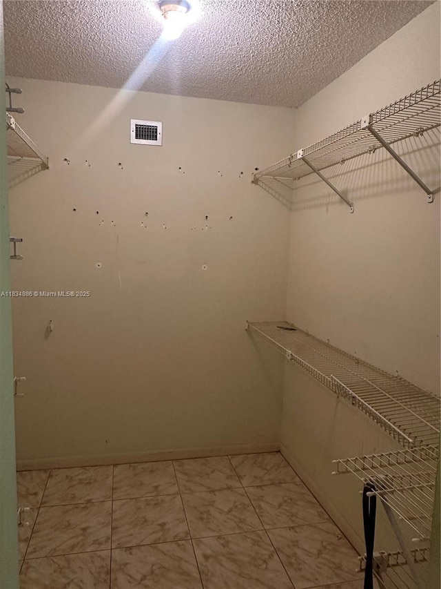 5945 Del Lago Cir Unit 201, Sunrise, FL 33313 - spacious closet featuring light marble finish flooring