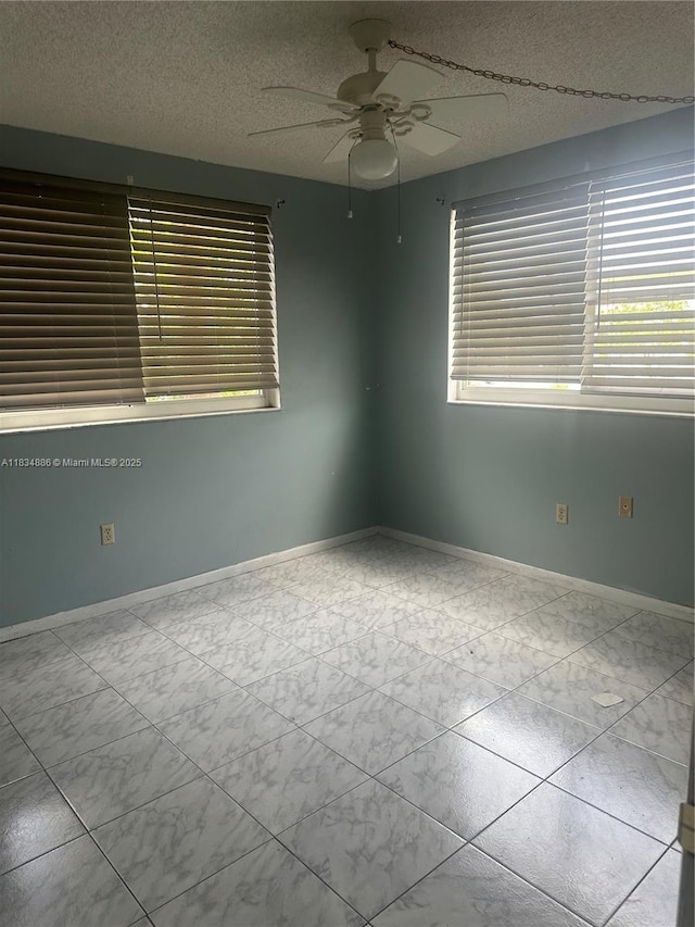 5945 Del Lago Cir Unit 201, Sunrise, FL 33313 - empty room with healthy amount of natural light, ceiling fan, marble look tiles, and a textured ceiling