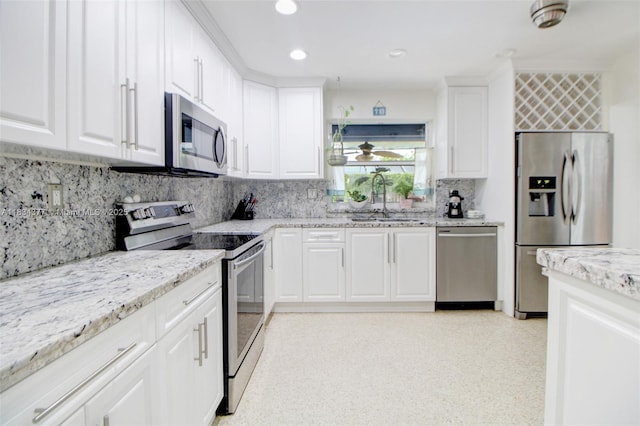 12000 NW 20th St, Pembroke Pines, FL 33026 - kitchen with appliances with stainless steel finishes, tasteful backsplash, light stone countertops, white cabinetry, and recessed lighting