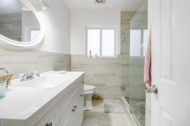 12000 NW 20th St, Pembroke Pines, FL 33026 - bathroom featuring vanity, tile walls, a shower stall, marble finish flooring, and wainscoting